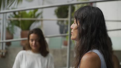 Yoga-Coach-Closing-Her-Eyes-Meditating-In-Nature-With-Her-Students,-Lima,-Peru