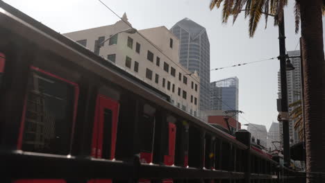 Slow-Motion-cinematic-shot-of-trolley-entering-downtown-San-Diego-station
