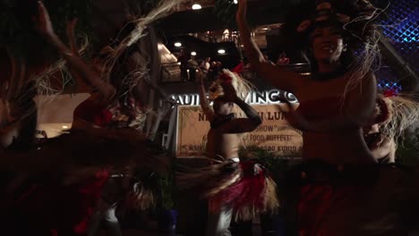 Traditional-Hawaiian-Luau-at-night-accompanied-by-Hula-dance-demonstration---Low-angle-wide-shot