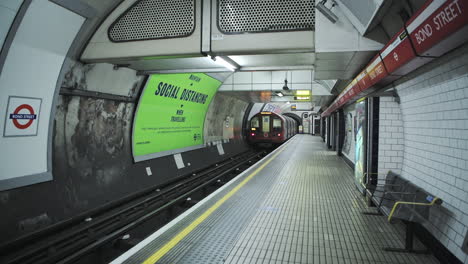 London-Underground-tube-train-in-Covid-19-Coronavirus-lockdown-pandemic-in-England,-UK-showing-Bond-Street-Station-empty,-quiet-and-deserted-with-no-people-on-the-platform