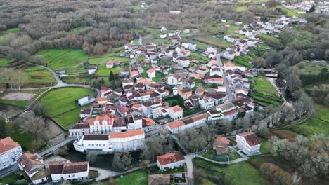 Panoramic-aerial-establishing-view-of-small-spanish-city-in-countryside-along-river