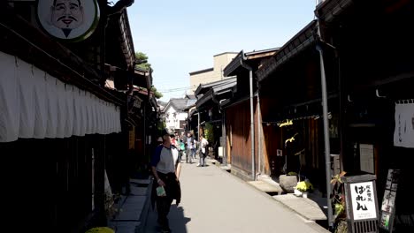People-are-walking-on-a-sunny-back-alley-street-in-Takayama's-Old-Town