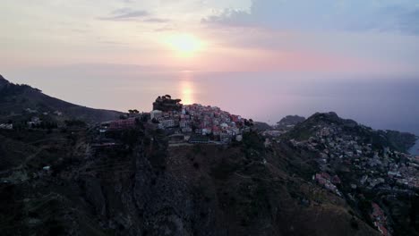 Flying-over-Castelmola-small-town-which-is-located-near-Taormina-during-sunset-with-a-drone