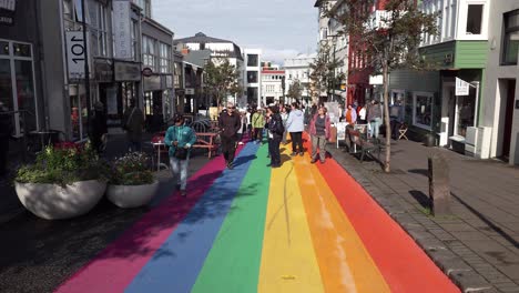 Rainbow-Street-With-Tourists-In-Central-Reykjavik,-Iceland---Wide-Shot
