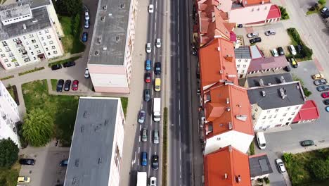 Street-traffic-and-red-rooftops-of-Elk-city-in-Poland,-aerial-view