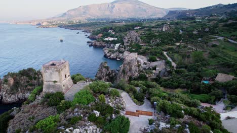 Orbiting-movement-aerial-drone-shot-over-Scopello-village-during-sunset