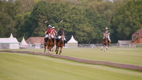 Polo-player-hits-ball-with-mallet-and-gallops-after-racing-against-the-other-team