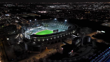 Drone-shot-circling-the-night-lit-Guaranteed-Rate-Field-stadium,-winter-in-Chicago