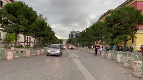 Pedestrians-crossing-streets,-Tirana-city-street-traffic,-Albania,-Europe