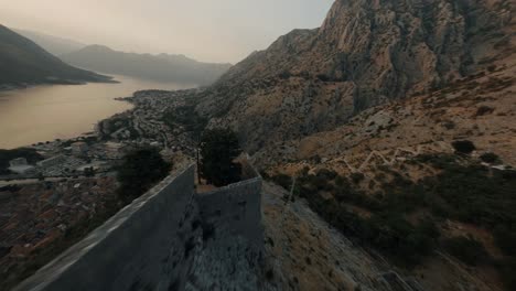 Flying-with-FPV-drone-in-Montenegro-during-sunset-over-old-town-of-Kotor