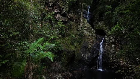 Water-cascading-down-moss-covered-waterfalls-hidden-deep-in-a-tropical-jungle-oasis