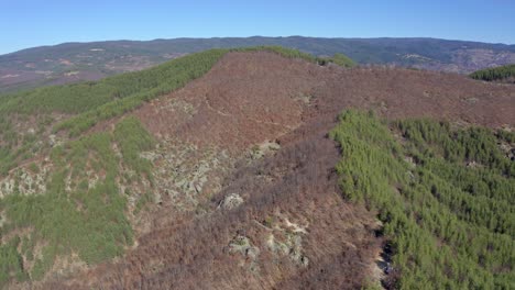 Drone-moving-around-t-he-slopes-of-Skribina,-a-place-known-for-its-miraculous-healing-powers-located-at-the-ranges-of-Rhodope-Mountains-in-Bulgaria
