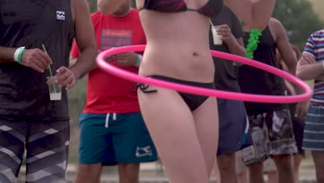 Woman-in-Bikini-Dancing-with-Hula-Hoop-in-Summer-Festival,-Slow-Motion
