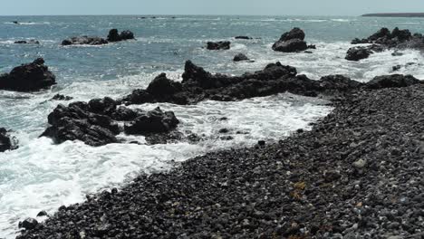Ocean-waves-splashing-over-rocky-coast-of-Tenerife,-Las-Galletas