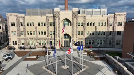 Flags-of-Virginia-Tech-displayed-in-front-of-a-campus-building