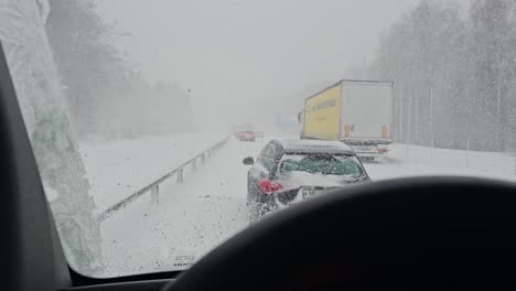 Cars-and-trucks-stuck-on-the-highway-in-the-winter-in-a-heavy-blizzard