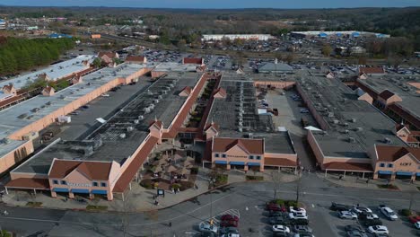 Aerial-lateral-shot-of-North-Georgia-Premium-Outlet-and-traffic-on-highway-in-background