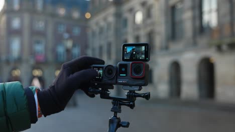 Recording-video-with-two-different-action-cameras,-content-creator-video-gear-comparison