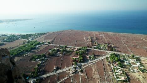 Aerial-drone-shot-flying-between-rocks-at-San-Vito-Lo-Capo-beach