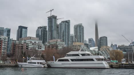 Timelapse-of-Toronto's-waterfront-with-yachts-docked-and-city-skyline-shrouded-in-mist