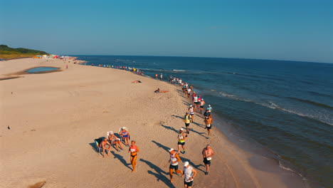 Running-marathon-on-the-beach-in-Jastarnia,-Poland-at-sunny-summer-day