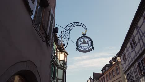 Scenic-wide-shot-of-decoration-plate-with-sun-setting-in-medieval-french-village-of-Kaysersberg,-France