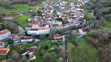 Panoramic-aerial-ascend-pullback-to-establish-scenic-Spanish-village-in-countryside-of-Ourense-Galicia-Spain