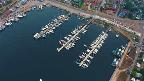 Aerial-view-of-marina-in-Jastarnia,-Poland-with-moored-luxurious-yachts