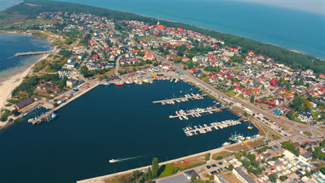 Panoramic-view-of-drone-flying-above-the-city-of-Jastarnia-with-marina-and-yachts-and-baltic-sea-in-the-background