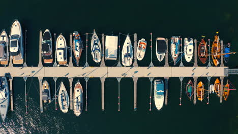 Drone-flying-around-the-marina-with-moored-yachts-and-boats-at-sunny-summer-day