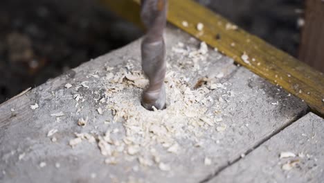 Drilling-hole-into-wood-panel-corner-for-applying-a-screw,-Close-up-shot