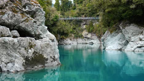 Capture-the-majesty-of-Hokitika-Gorge-with-a-mesmerising-long-shot-of-a-suspension-bridge-over-it
