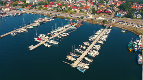 Drone-flying-arount-the-marina-and-moored-yachts,-boats-and-motoroboats-in-Poland
