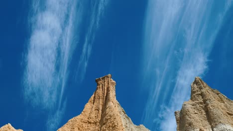 Clay-Cliff's-serenity:-Clouds-drift-above-captivating-clay-formations-in-mesmerizing-stock-footage