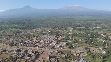 Scenic-panorama-of-African-village-at-Mount-Kilimanjaro-footstep,-aerial-view