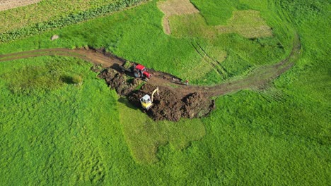 View-from-Above-Of-Backhoe-Scooping-Soil-On-The-Field
