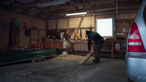 A-Man-Transporting-the-Lumber-Into-the-Woodworking-Zone-in-Indre-Fosen,-Trondelag-County,-Norway---Static-Shot