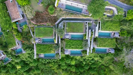Nested-Terraced-Villas-on-Hilltop-at-Maua-Resort-in-Nusa-Penida-Klungkung-Regency,-Bali-Indonesia---Aerial-top-down-pan