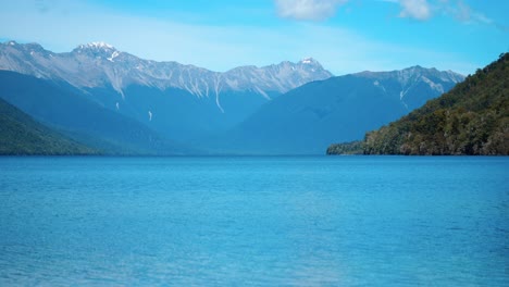 Serene-long-shot-of-Lake-Rotoroa,-framed-by-majestic-mountains