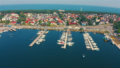 Panoramic-drone-view-of-yahcts-moored-in-the-marina-in-Jastarnia,-Poland-at-sunny-summer-day