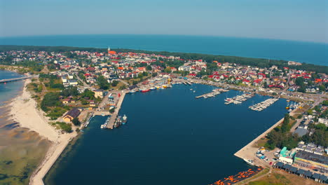 Drone-flying-around-the-marina-in-Jastarnia,-Poland-with-moored-yachts