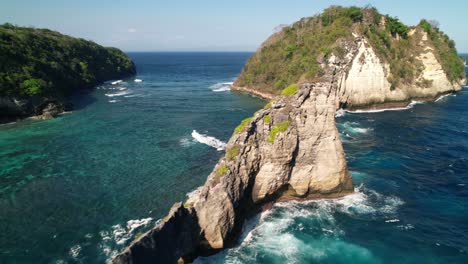 Flying-Along-Steep-Cliffs-of-Nusa-Batupadasan-Island-In-Front-of-Nusa-Penida's-Atuh-Beach-in-Indonesia