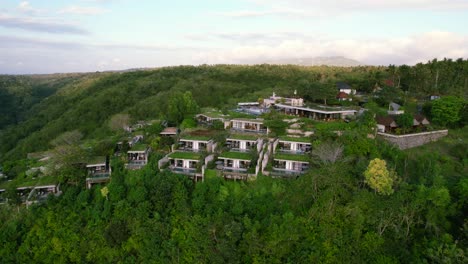 Hilltop-Deluxe-Maua-Resort-in-Nusa-Penida,-Bali-Indonesia---Aerial-Establishing-View-of-Patchy-Terraced-Nested-Villas-in-Tropical-Eco-Environment