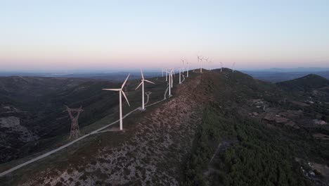 Wind-turbines-on-hillside-produce-sustainable-green-energy-Valencia-Spain-aerial