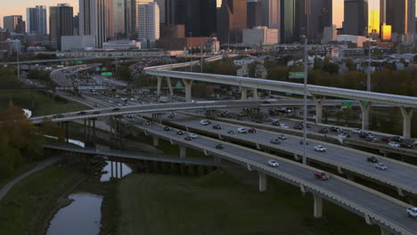 Aerial-shot-of-cars-on-I-45-North-freeway-and-reveal-of-downtown-Houston,-Texas