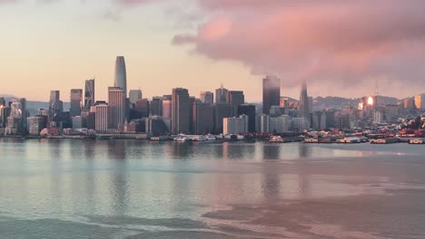 Aerial-static-view-of-vibrant-pink-sunrise-over-San-Francisco-skyline,-USA