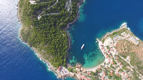 Overhead-drone-shot-orbiting-around-the-peninsula-of-Agriosiko-Beach,-a-secret-getaway-in-the-island-of-Kefalonia-in-Western-Greece