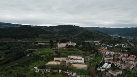 Panoramic-drone-dolly-to-Catholic-seminary-religious-school-on-hill-by-highway