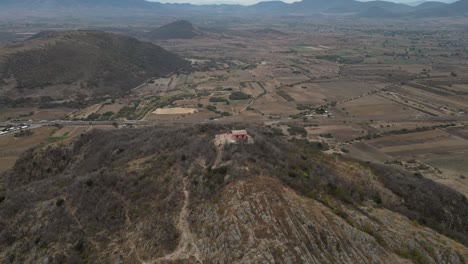 Aerial-hyperlpase-mountain-Danush-at-the-site-of-Dainzu-Macuilxochitl-in-Oaxaca,-Mexico
