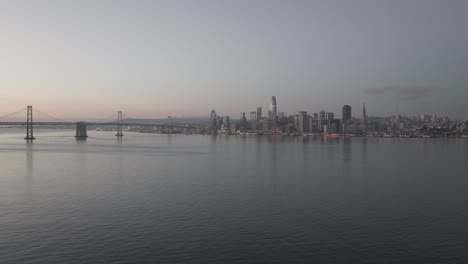 Wide-dawn-aerial-view-of-San-Francisco-Skyline-over-water
